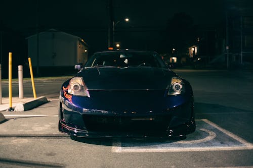 Black Car Parked on Parking Lot During Night Time