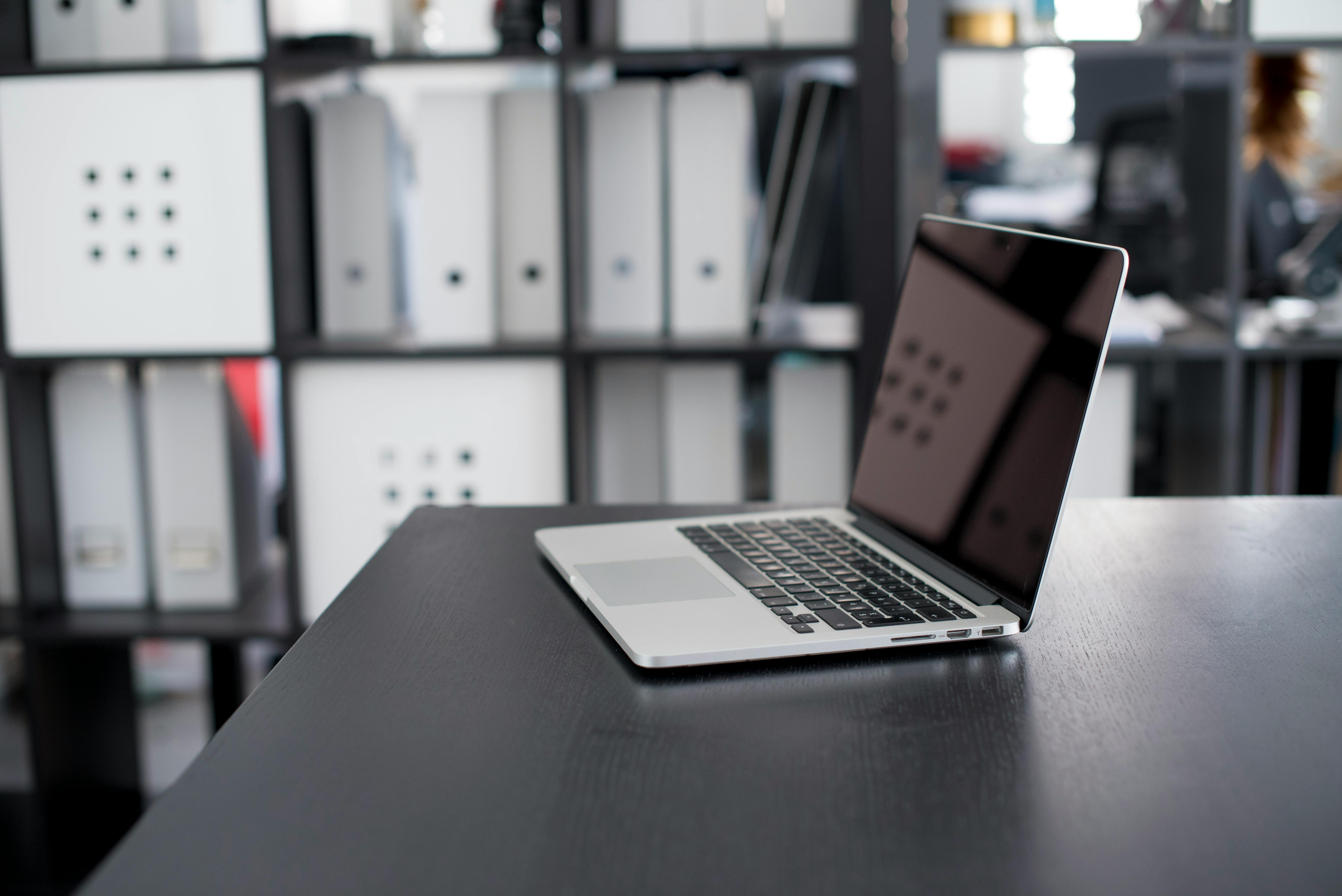 Macbook Pro on Brown Wooden Table