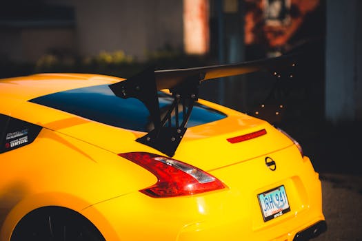 Close-up of a sleek yellow sports car with a prominent spoiler. Captures urban automotive style.