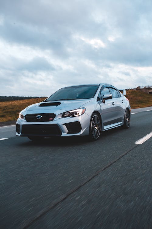 Free Silver Car on an Asphalt Road and Overcast in Sky Stock Photo