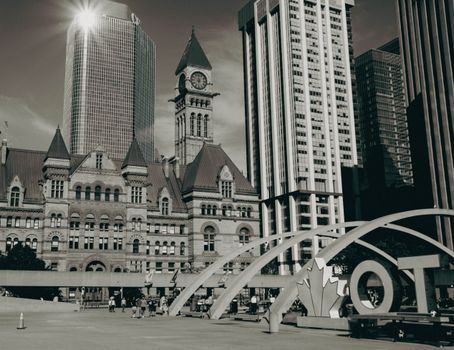Black and white photograph capturing Toronto's Old City Hall and modern skyline.