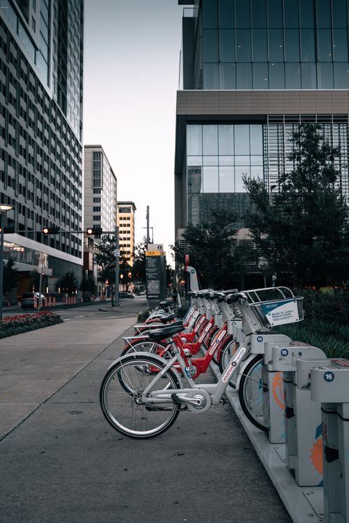 Free Bicycles lined up at a rental stand in downtown Houston, showcasing urban mobility. Stock Photo
