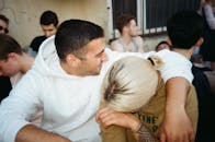 在轻松的户外聚会中，两个朋友温暖地拥抱