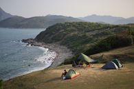 Aerial view of tents and campers on the scenic Hong Kong coastline.