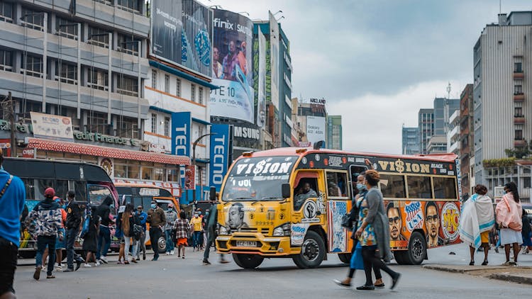 People Near Bus On Street In City