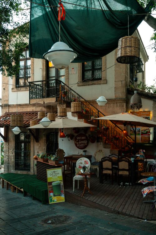 Free Cozy outdoor dining area with vintage decor under soft lighting, perfect for al fresco dining. Stock Photo