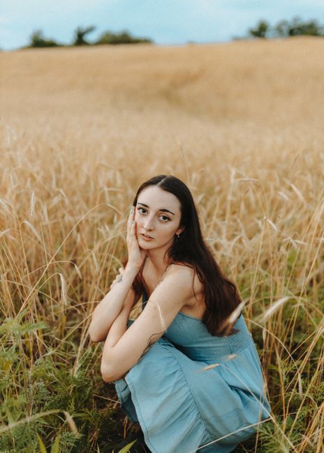 Portrait of a woman in a serene wheat field setting, Des Moines, Iowa.