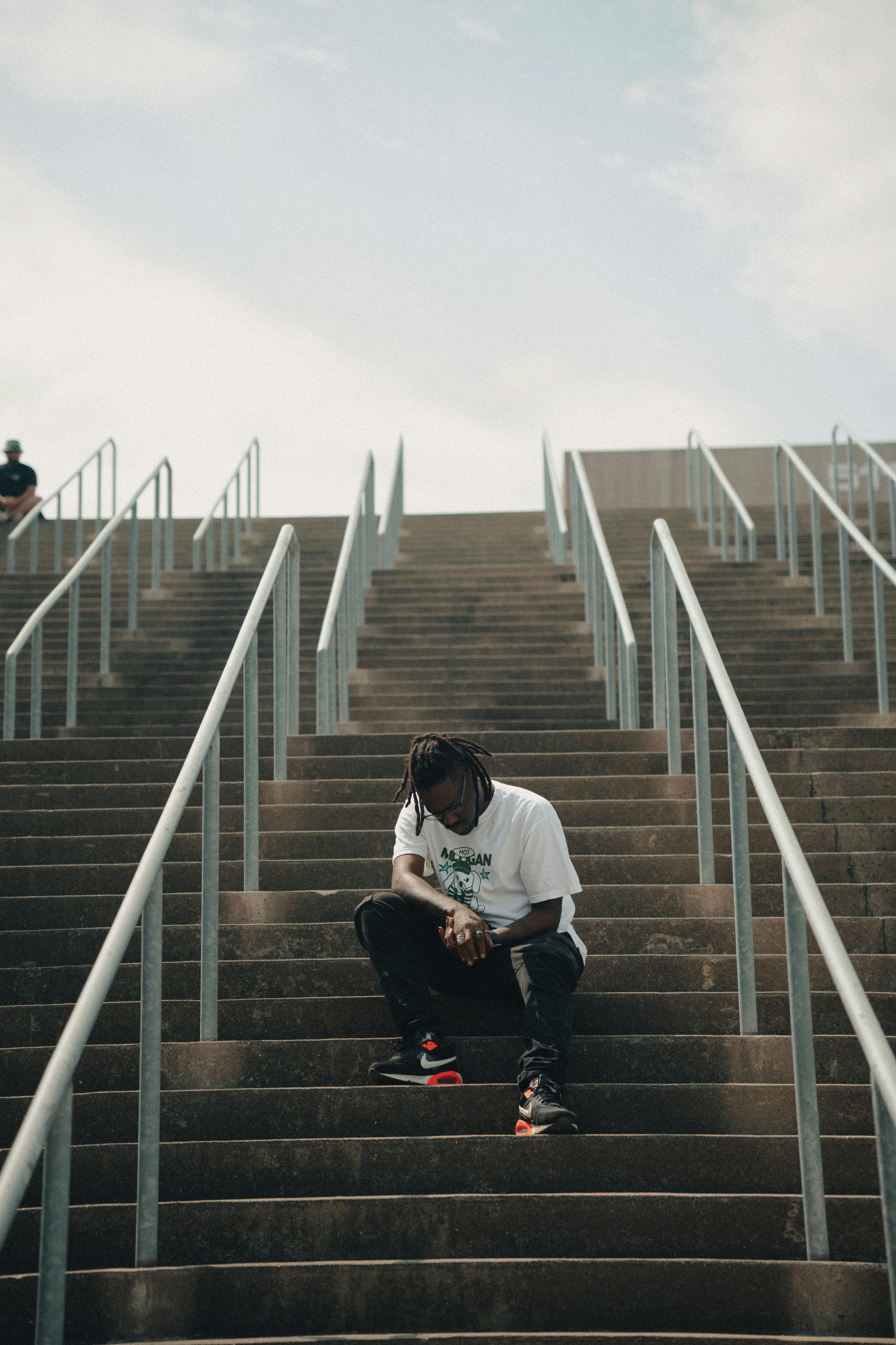 Man Sitting On Train Steps Free Stock Photo