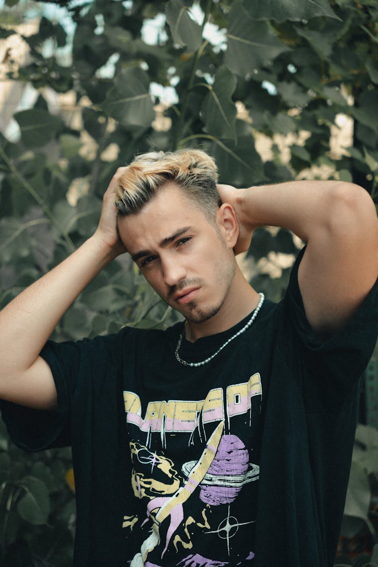 Portrait Of Young Man In Tree Background