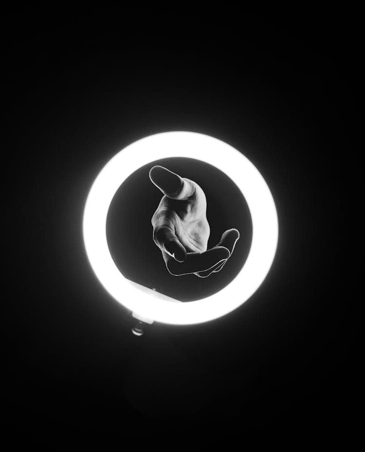 Abstract Black And White Photo Of A Hand In A Shining Circle