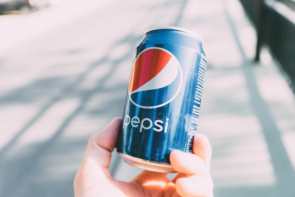 Person Holding Pepsi Can