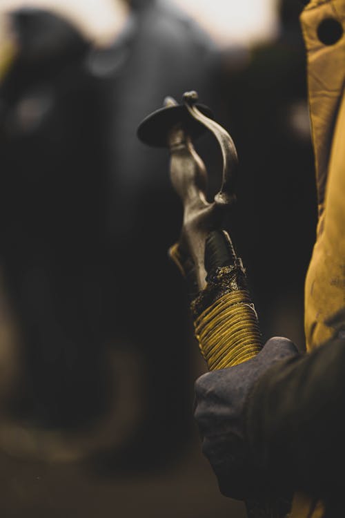 Hand Holding Buddhist Figurine