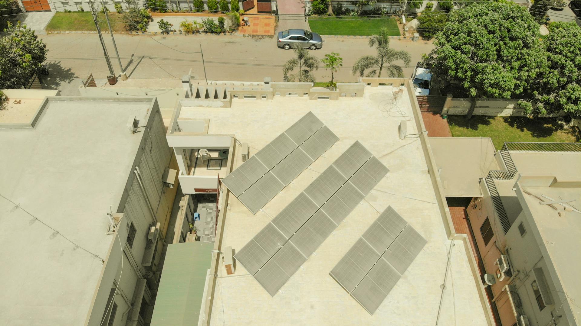 Aerial shot of solar panels on a rooftop in Karachi, highlighting sustainable energy solutions in urban settings.