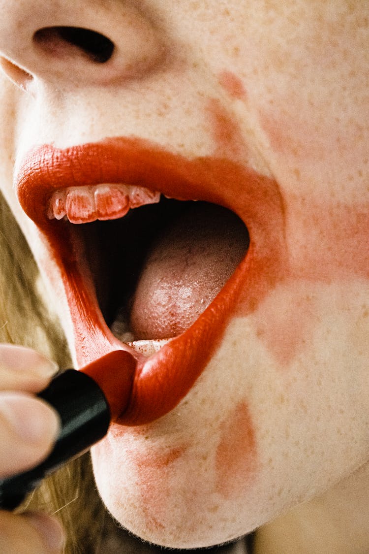 Woman Applying A Red Lipstick