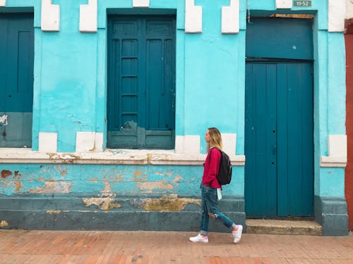 Free Woman Walking Street With Blue Building Stock Photo