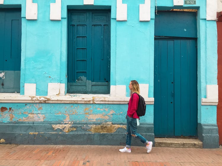 Woman Walking Street With Blue Building