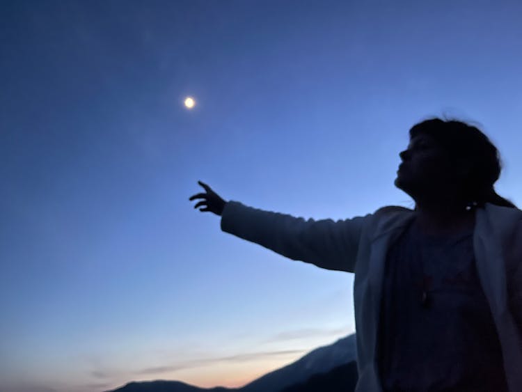 Woman In White Coat Reaching For The Sun