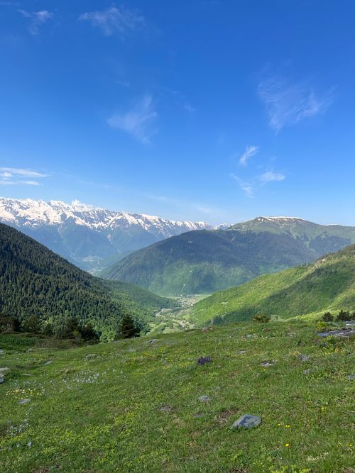Free Breathtaking landscape of the Caucasus Mountains in Georgia with lush greenery and a clear blue sky. Stock Photo