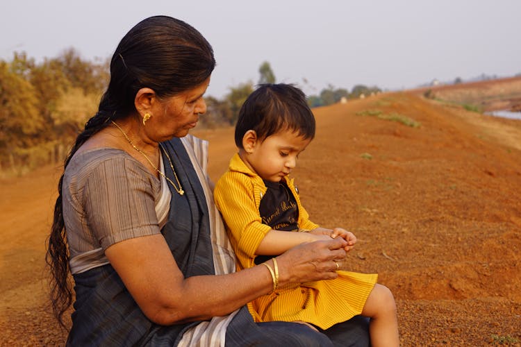 Grandmother With Grandson In Field