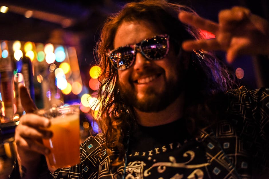 Man in Black and White Crew Neck Shirt Wearing Black Sunglasses