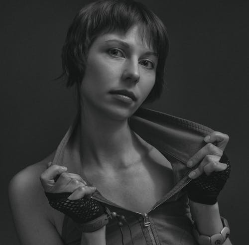 Grayscale Portrait of a Woman Holding Her Collar