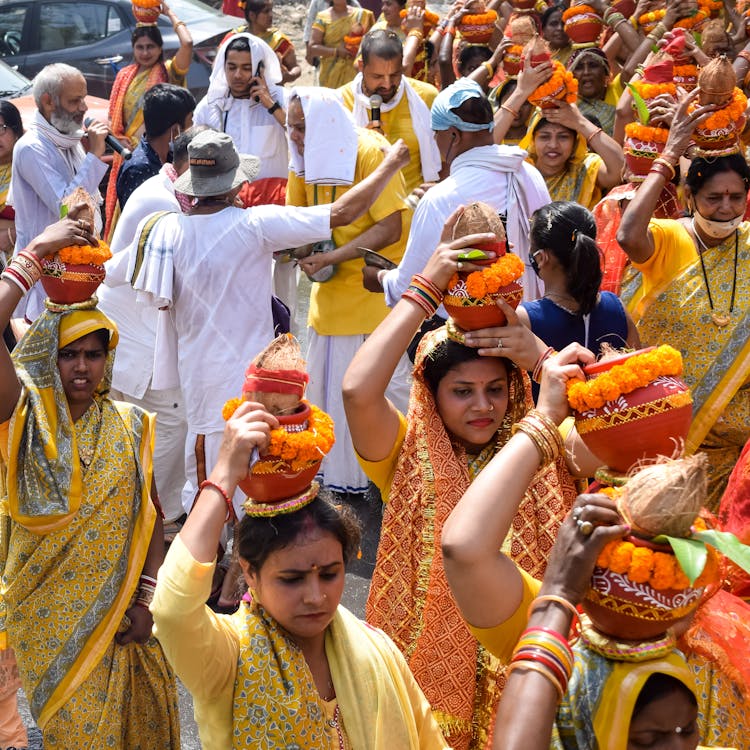 Crowd With Vases On Heads