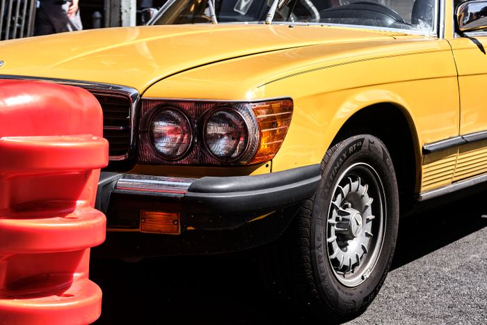 Close-up of a car's gleaming front end after trim restoration