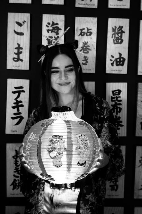 Woman Wearing a Robe Holding a Japanese Lantern