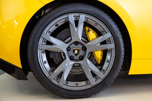 Free Detailed view of a Lamborghini wheel rim showcasing sleek design and elegance. Stock Photo