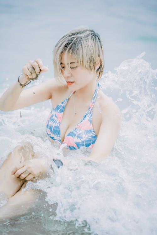 Woman in Blue Bikini Top Swimming at the Beach