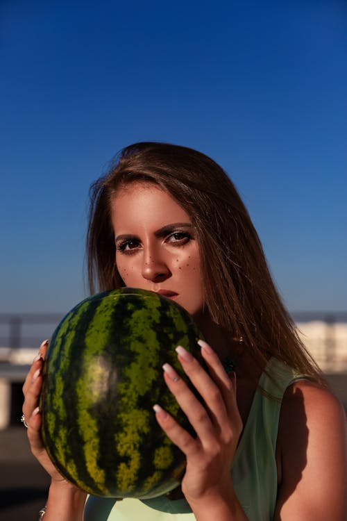 A Woman Holding a Watermelon