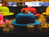 Vibrant display of assorted colorful cakes and desserts, perfect for celebrations.