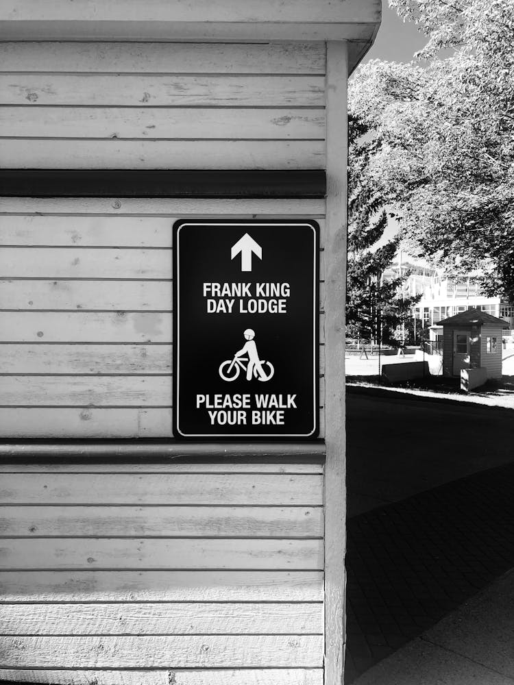 Information Sign On A Wooden Building Exterior 