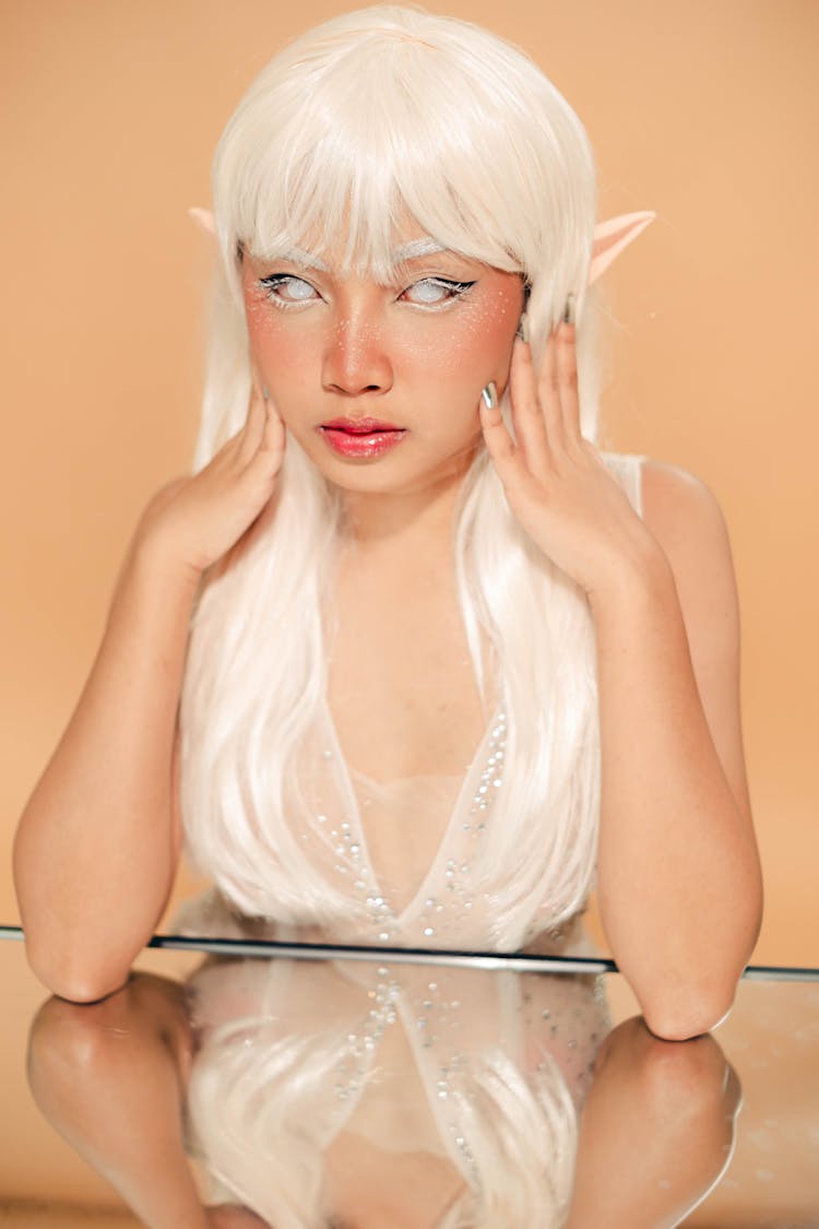 Portrait Of A Pixie With White Hair On A Beige Background