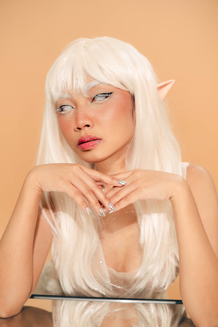 Portrait Of A Pixie With White Hair Reflecting In A Mirror Table