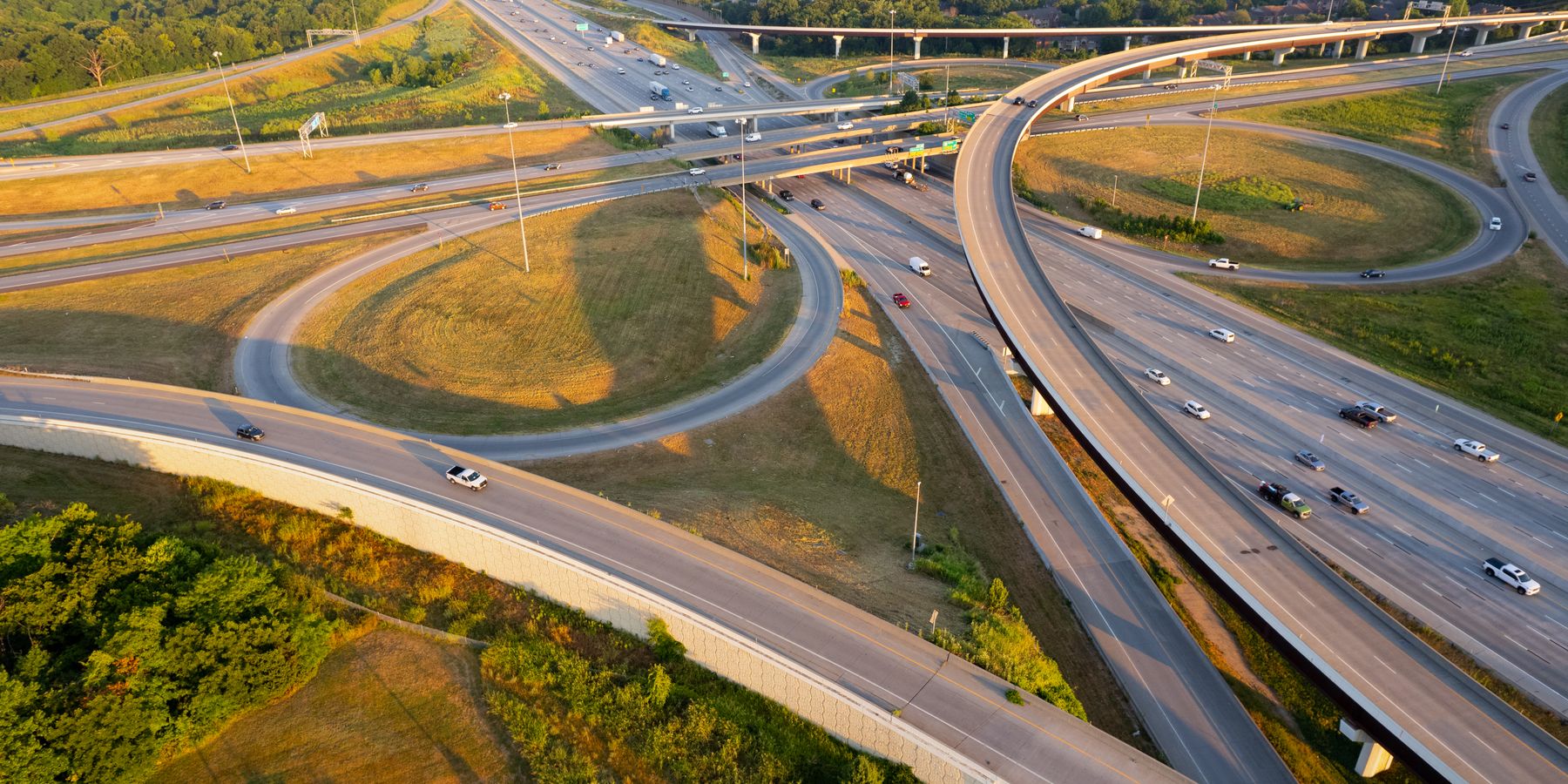 Stunning aerial shot of a highway interchange in Overland Park, Kansas during golden hour, showcasing intricate road networks.