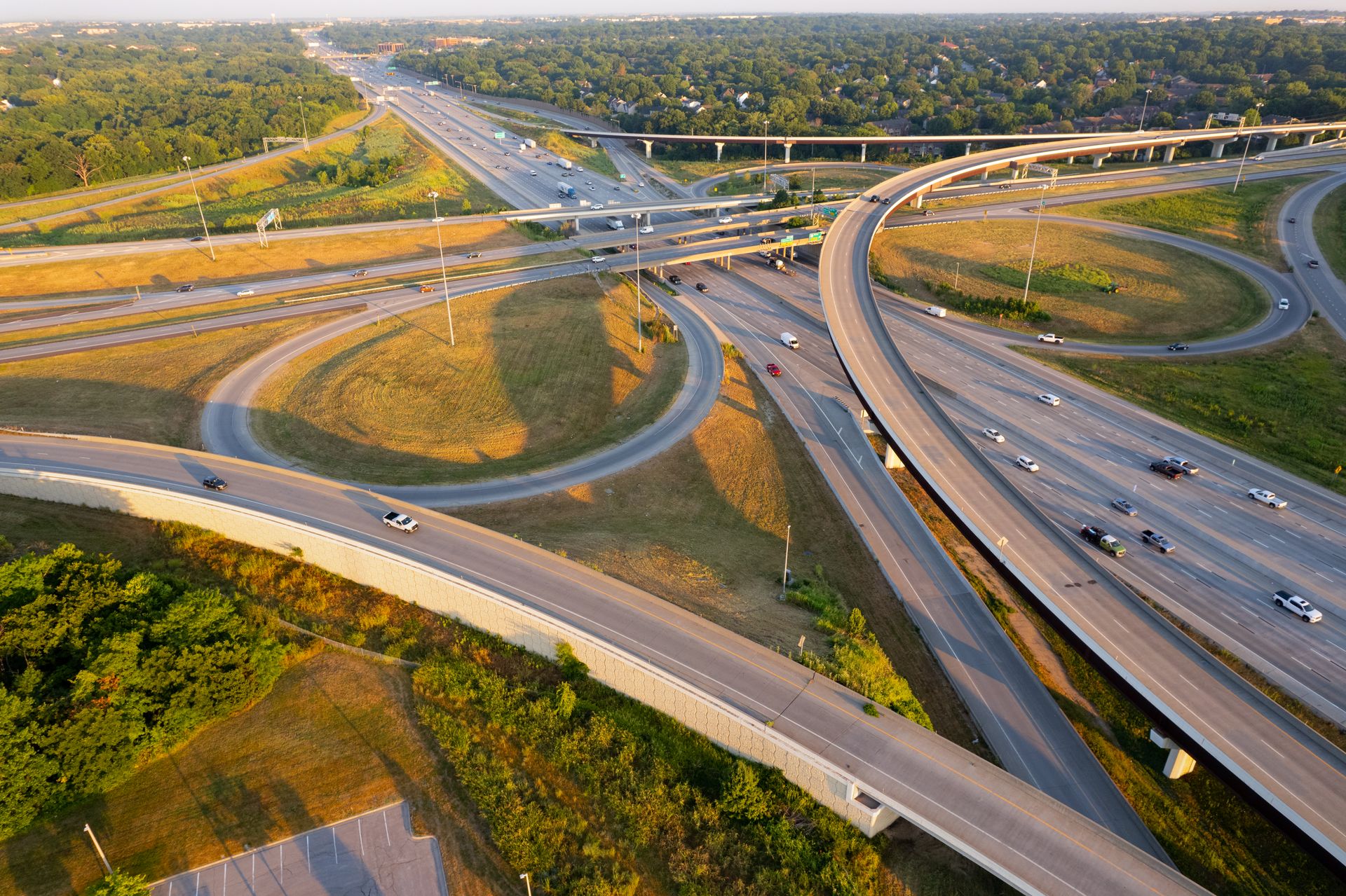 Stunning aerial shot of a highway interchange in Overland Park, Kansas during golden hour, showcasing intricate road networks.