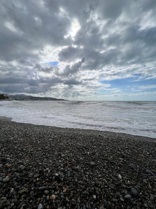 A Rocky Shore on the Beach Under the Cloudy Sky