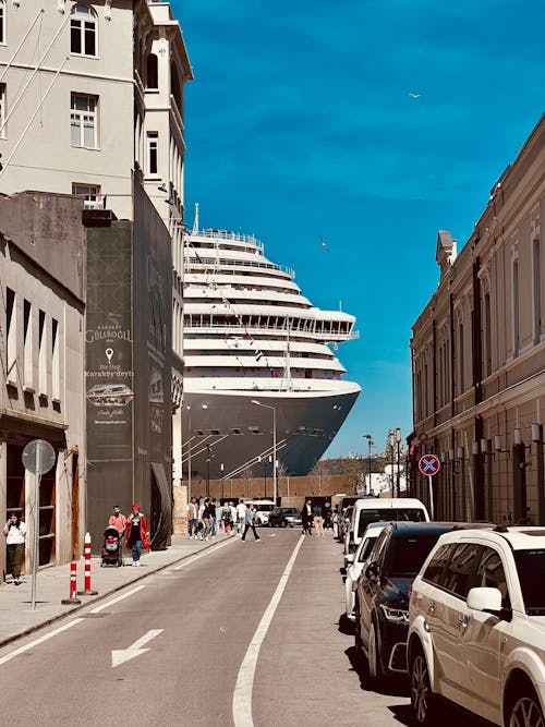 White Cruise Ship on Dock Near Concrete Buildings