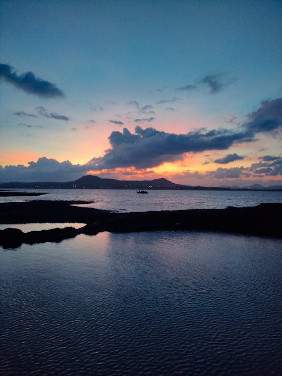 Scenic Seascape with a Distant Mountain at Dusk