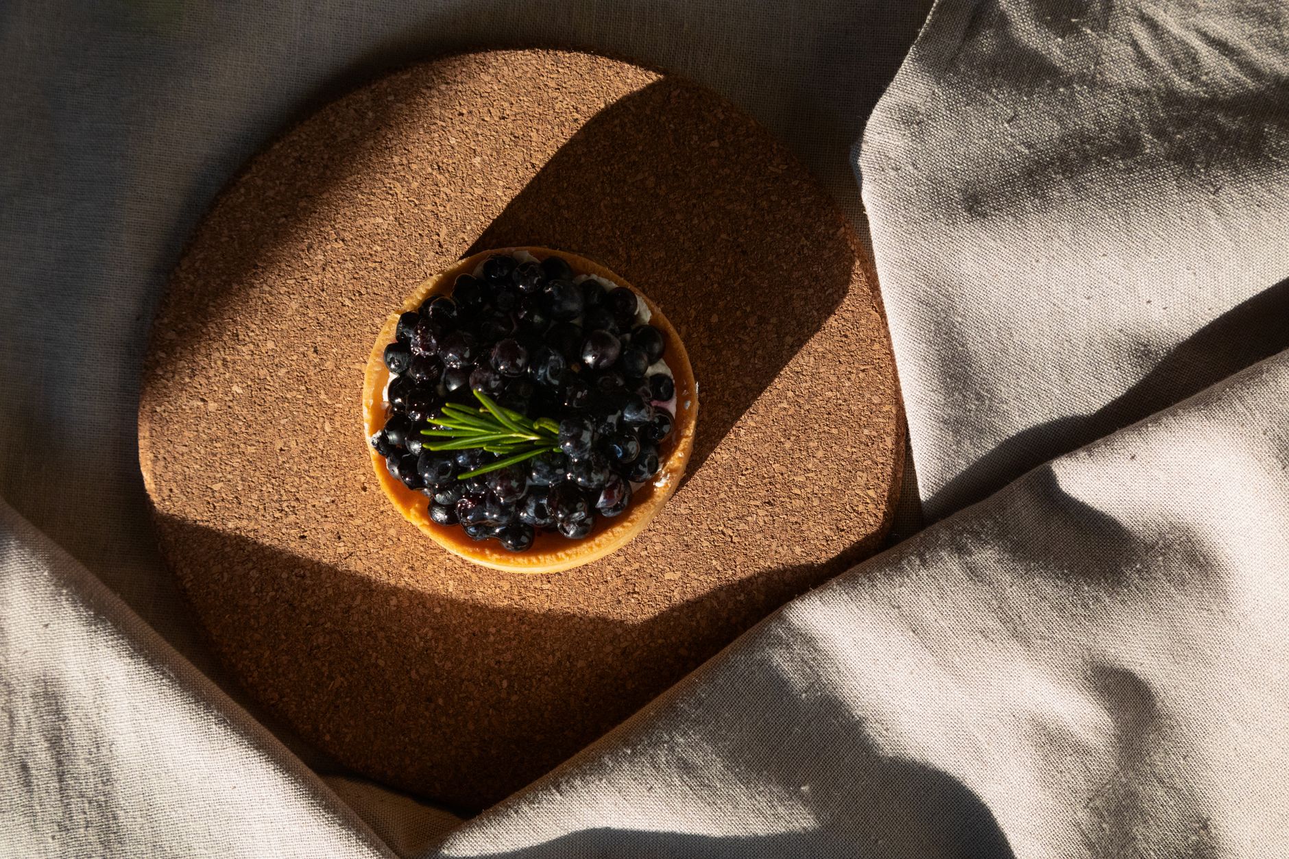 Sliced blueberry hazelnut frangipane tart showing creamy filling and berries