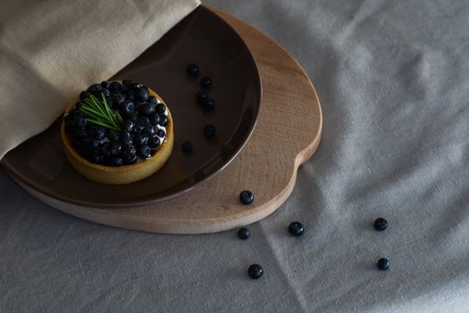 A Blueberry Tart on a Ceramic Plate
