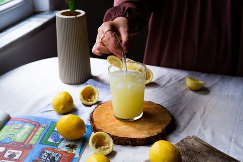 Free Enjoy a refreshing glass of lemonade with fresh lemons and ice, perfect for a sunny day. Stock Photo