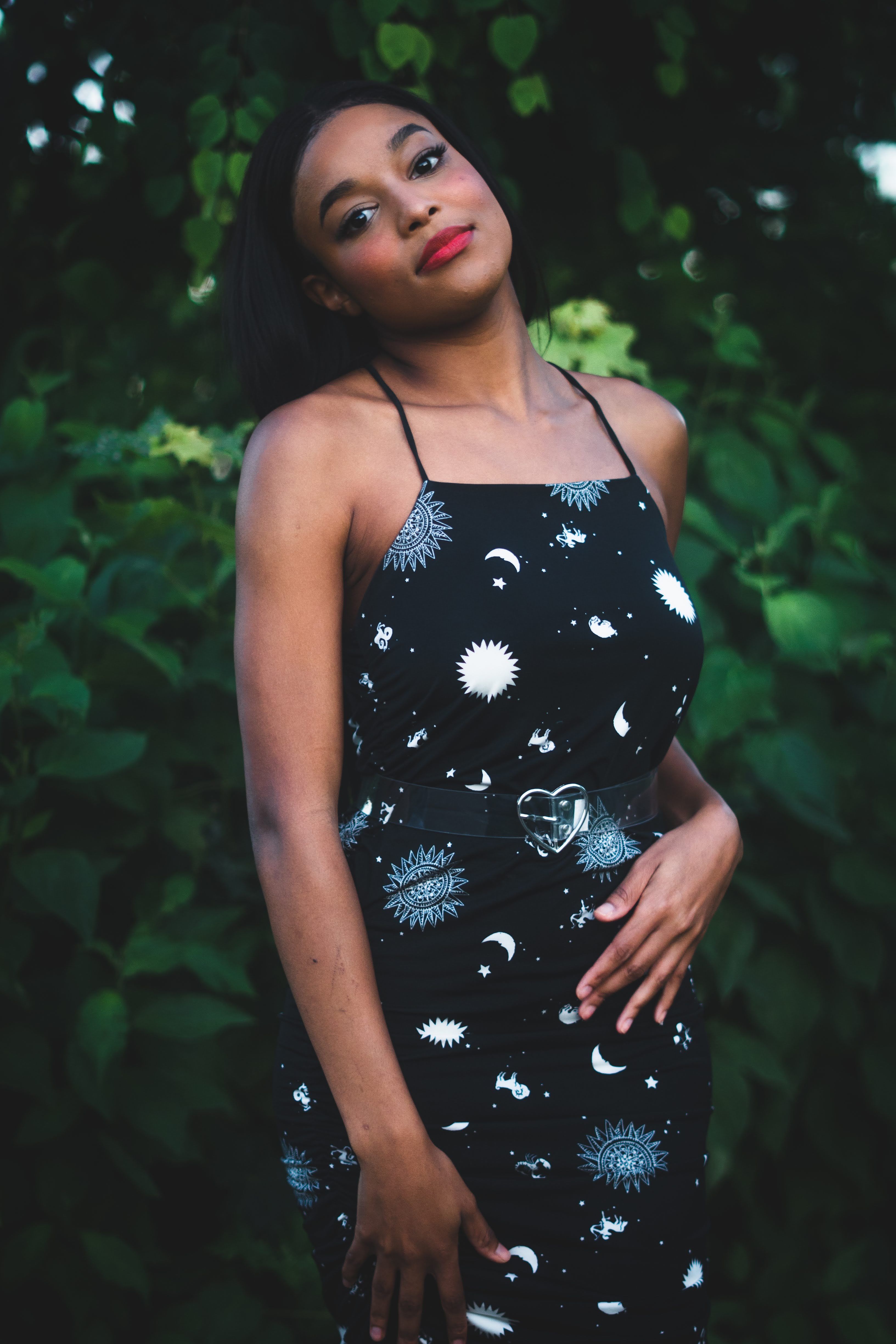 A Woman in Black Printed Dress Smiling · Free Stock Photo