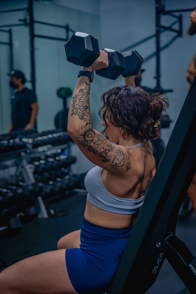 A Woman Lifting Dumbbells