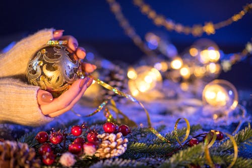 Close-up Woman Hands Holding Christmas Ball with New Year Decor