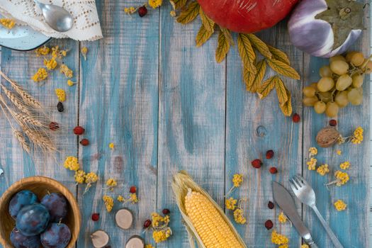 Top view of various fruits and vegetables on a rustic wooden table, showcasing a vibrant harvest.