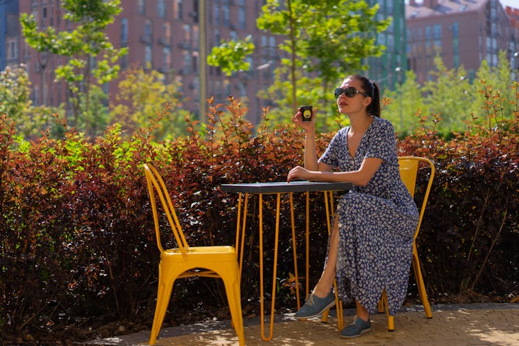 Woman Drinking Coffee Outdoors
