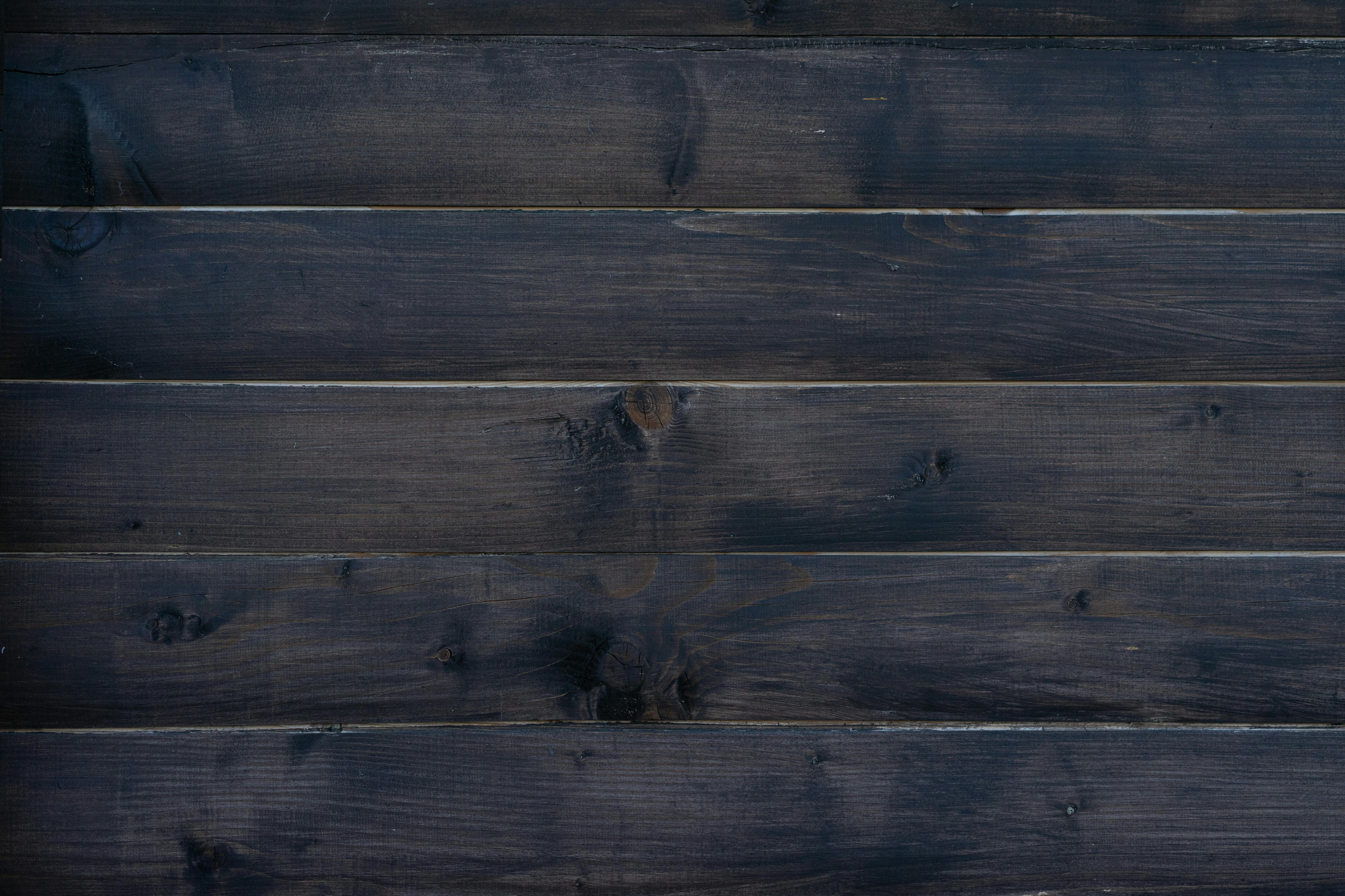 Rustic dark wooden planks create a natural textured background for design projects.