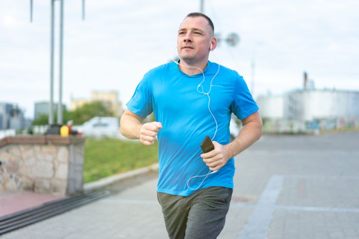 A man jogging with earphones